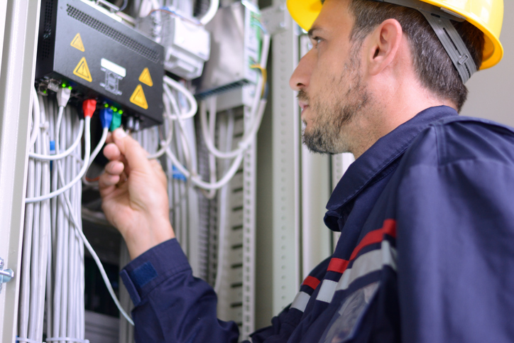 Electrician connecting cable to the switch